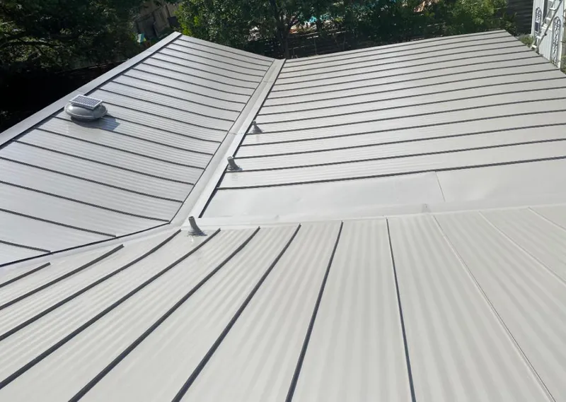 Solar attic fan installed on a metal roof for Roof Ventilation in University Park